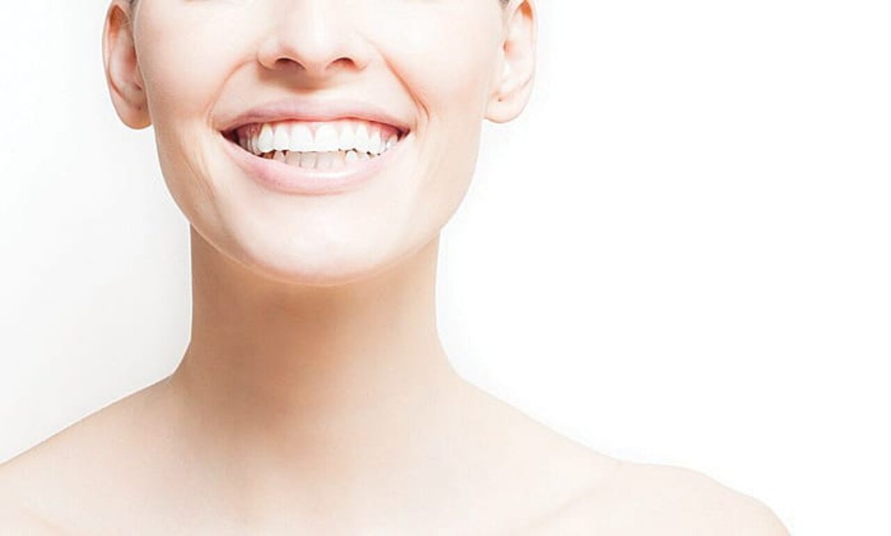 Woman smiling, white background, copyspace.